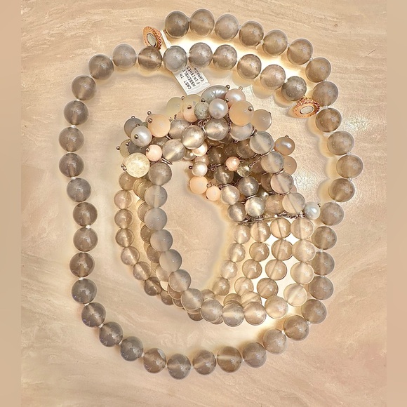 Saks fifth Avenue moon stone hand strung. New in duster. 14k gold plated clasp
